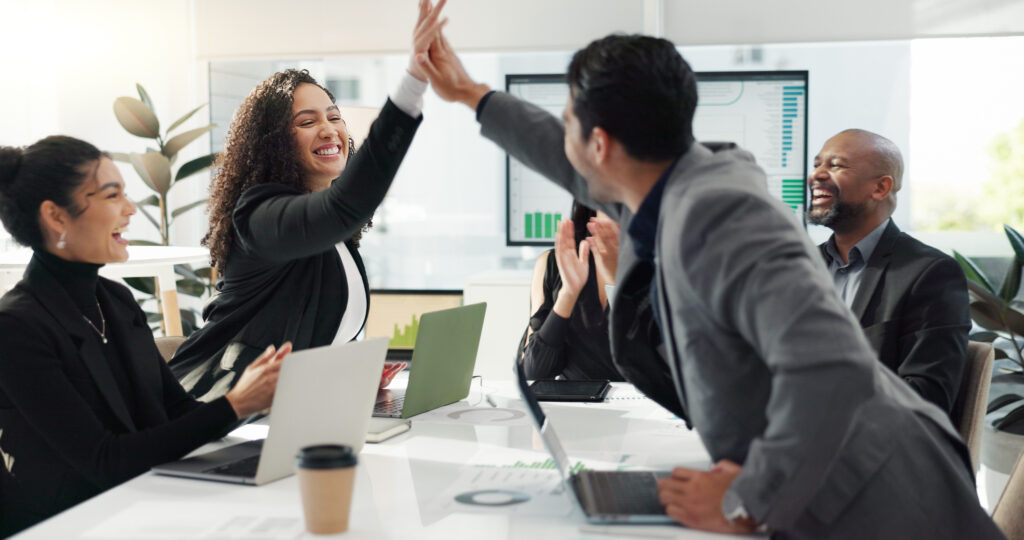 Business people, high five and meeting success, celebration and achievement of sales news, target or goals. Happy group applause, support and excited for bonus, winning or results on computer screen.